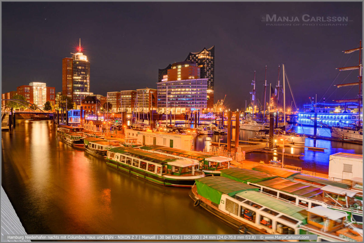 Barkassen Boote im Hamburger Niederhafen nachts mit Columbus Haus und Elphi
